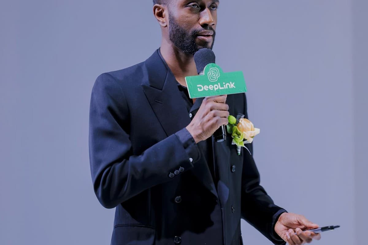 Joel Roberts speaking on stage at an industry event